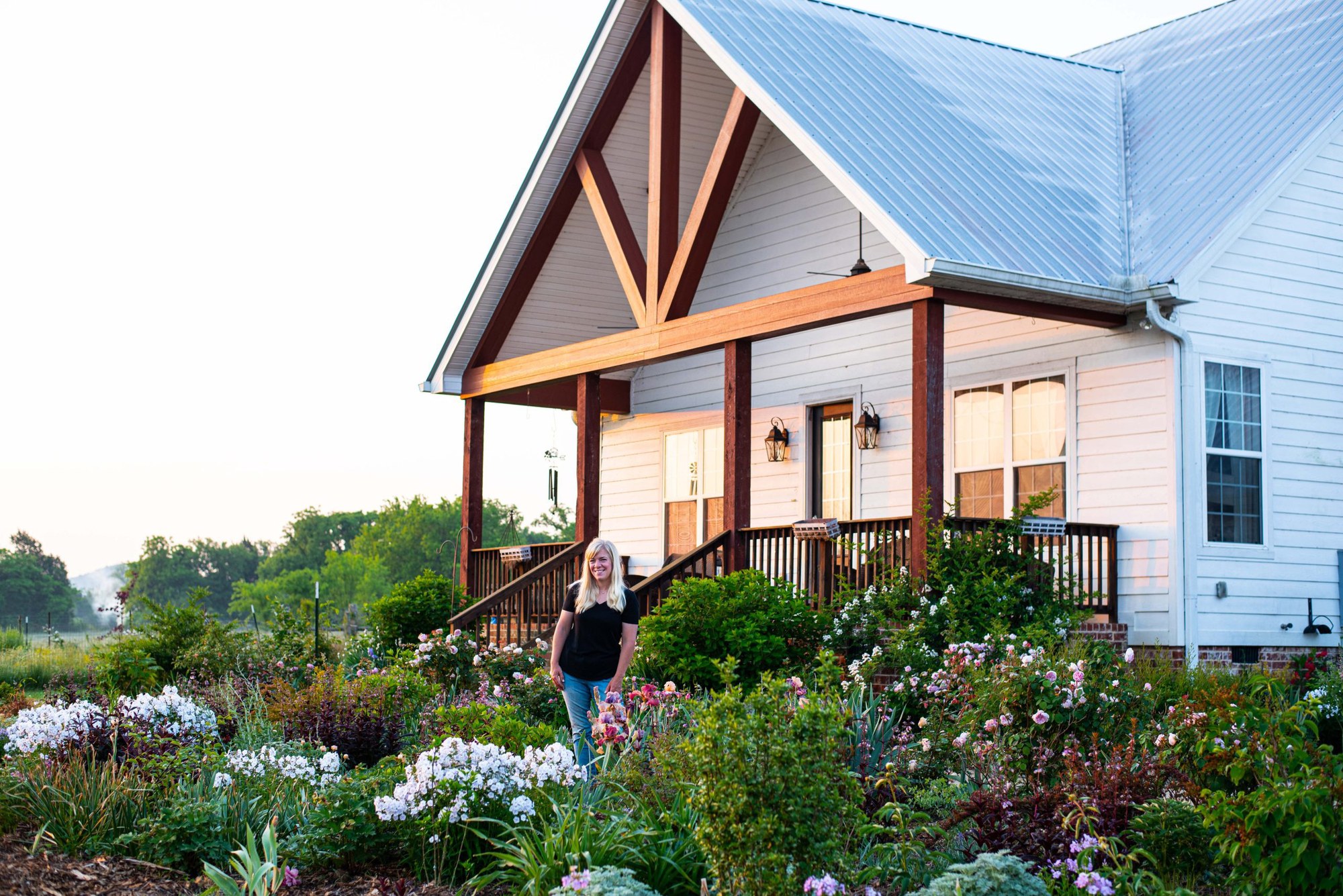 Kara Jamison standing in her flower garden at the Blooming Joy farm