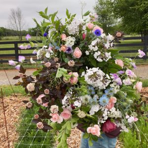 Lush spring garden bouquet with pink, blue and white blooms